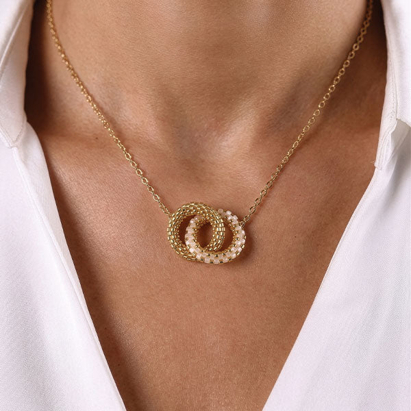 Handmade Miyuki bead necklace with interlocking gold and ivory circular pendants and 24K gold plated beads worn on neck