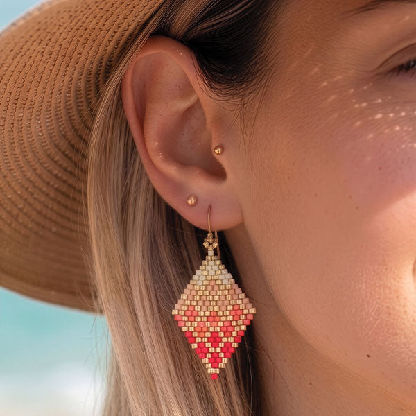 Handmade Miyuki bead earrings in ivory, blush pink, and coral tones with geometric woven design and 24K gold plated elements
