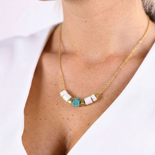 Ivory Tila bead bar necklace with 24K gold plated chain displayed on luxury jewelry box