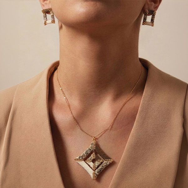 Handmade Miyuki bead geometric necklace and earrings set in neutral tones with 24K gold plated elements worn together