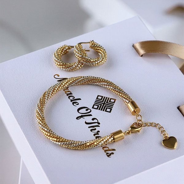 Handmade Miyuki bead bracelet and hoop earrings in gold tones with twisted design and 24K gold plated elements displayed in gift box