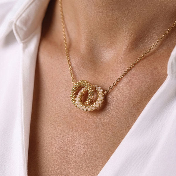 Handmade Miyuki bead necklace with interlocking gold and ivory circular pendants and 24K gold plated beads worn on neck