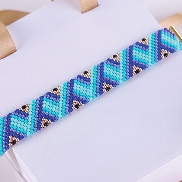 Set of handmade Miyuki bead bracelets with ocean-inspired geometric patterns in turquoise, aqua, navy, and black tones featuring 24K gold plated beads
