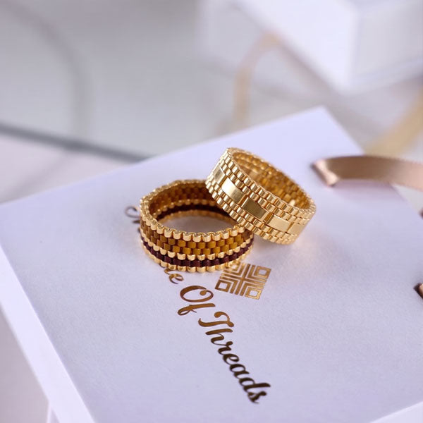 Two handmade Tila bead rings in black, amber and gold and full gold designs with 24K gold plated beads