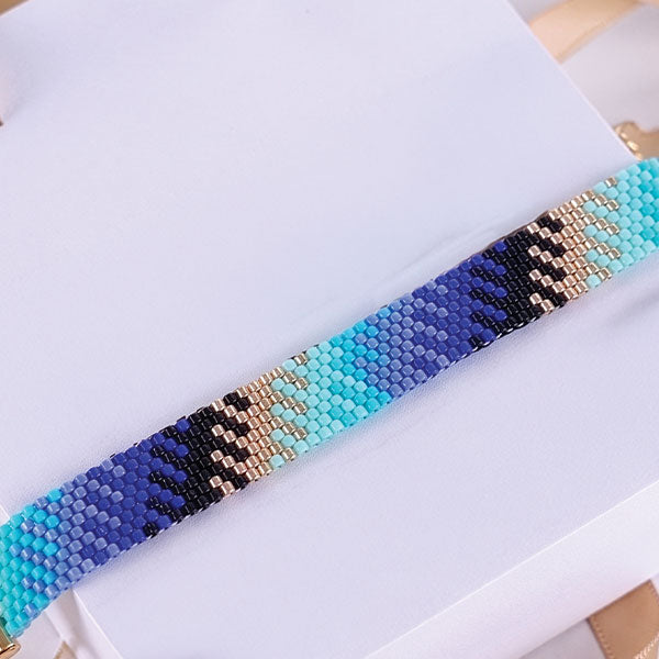 Set of handmade Miyuki bead bracelets with ocean-inspired geometric patterns in turquoise, aqua, navy, and black tones featuring 24K gold plated beads