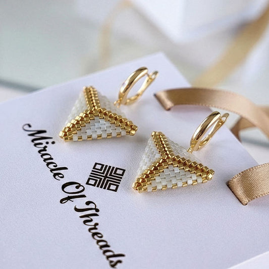 Handmade ivory Miyuki triangle earrings with 24K gold plated hoops displayed on luxury jewelry box