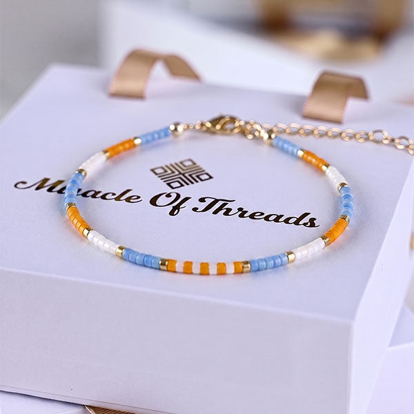 Handmade Miyuki bead anklet in sky blue, orange, white and gold with 24K gold plated beads and adjustable chain