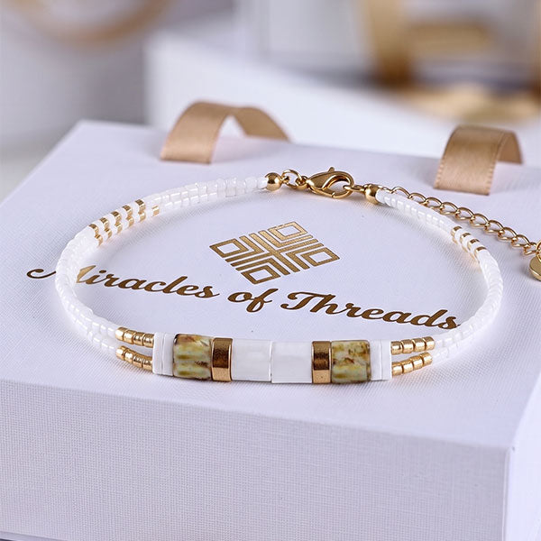 Handmade Tila and Miyuki bead anklet in white, natural stone and gold tones with 24K gold plated beads and adjustable chain
