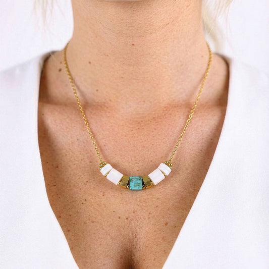 Ivory Tila bead bar necklace with 24K gold plated chain displayed on luxury jewelry box