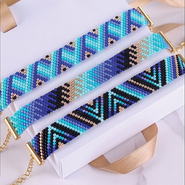 Set of handmade Miyuki bead bracelets with ocean-inspired geometric patterns in turquoise, aqua, navy, and black tones featuring 24K gold plated beads