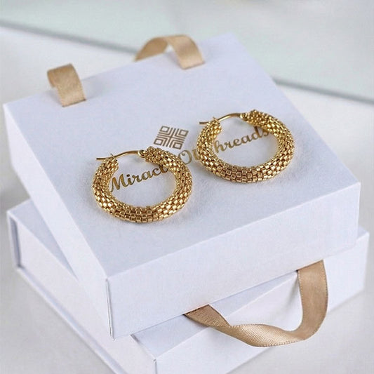 Handmade gold Miyuki bead hoop earrings with woven texture and 24K gold plated hooks displayed on luxury jewelry box
