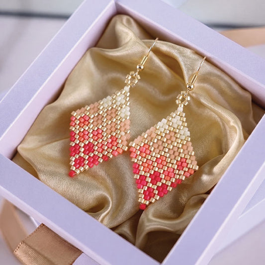 Handmade Miyuki bead earrings in ivory, blush pink, and coral tones with geometric woven design and 24K gold plated elements