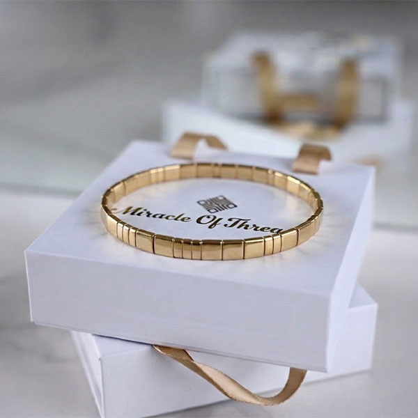 Handmade Miyuki Tila bead bracelet fully accented with 24K gold-plated flat square beads