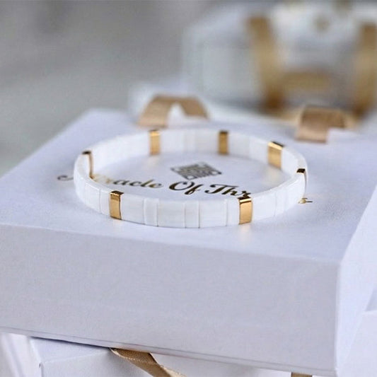 Handmade Miyuki Tila bead bracelet in ivory white with 24K gold-plated accents and minimalist flat design