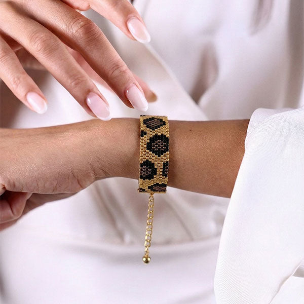 Handmade Miyuki bead bracelet in black and gold with panther-inspired pattern and 24K gold-plated beads