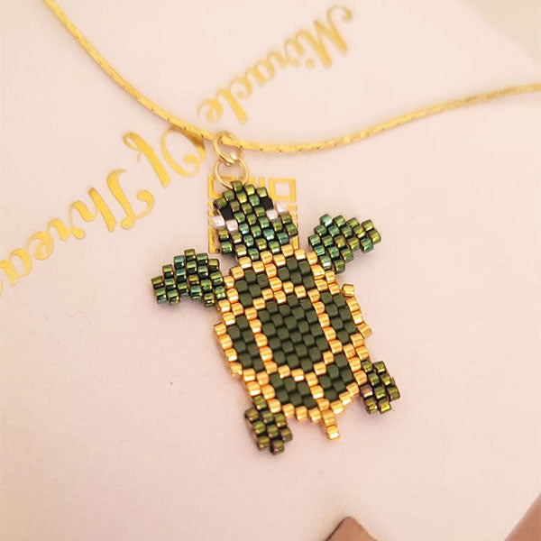 Handmade Miyuki bead turtle necklace in green and gold tones with 24K gold plated beads on delicate gold chain