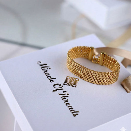 Handmade gold Miyuki bead bracelet with woven mesh texture and 24K gold plated beads on wrist