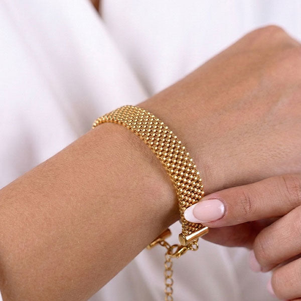 Handmade gold Miyuki bead bracelet with woven mesh texture and 24K gold plated beads on wrist